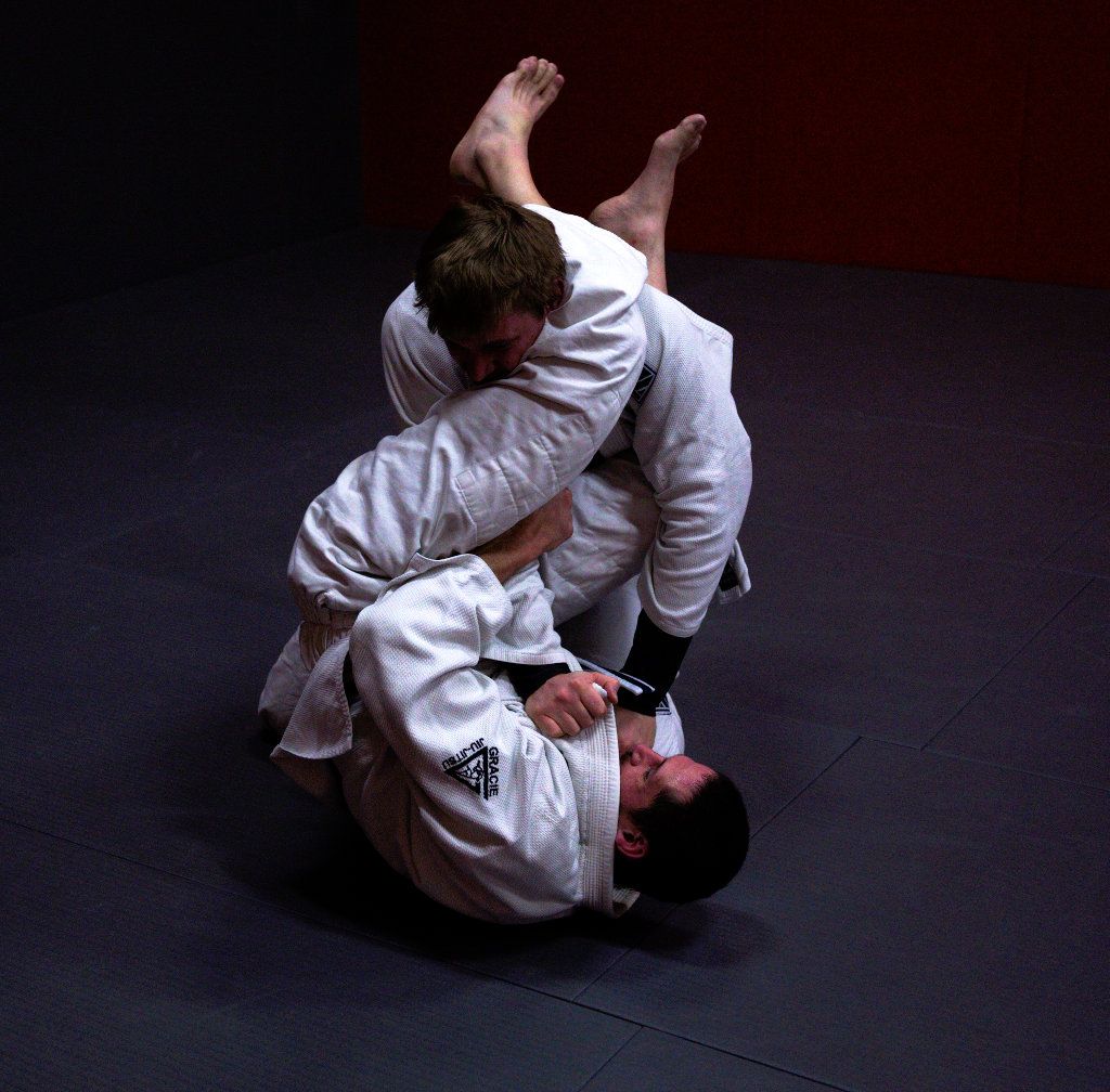 Adult Jiu-Jitsu students training an armlock from guard at Invictus, Woodbury MN