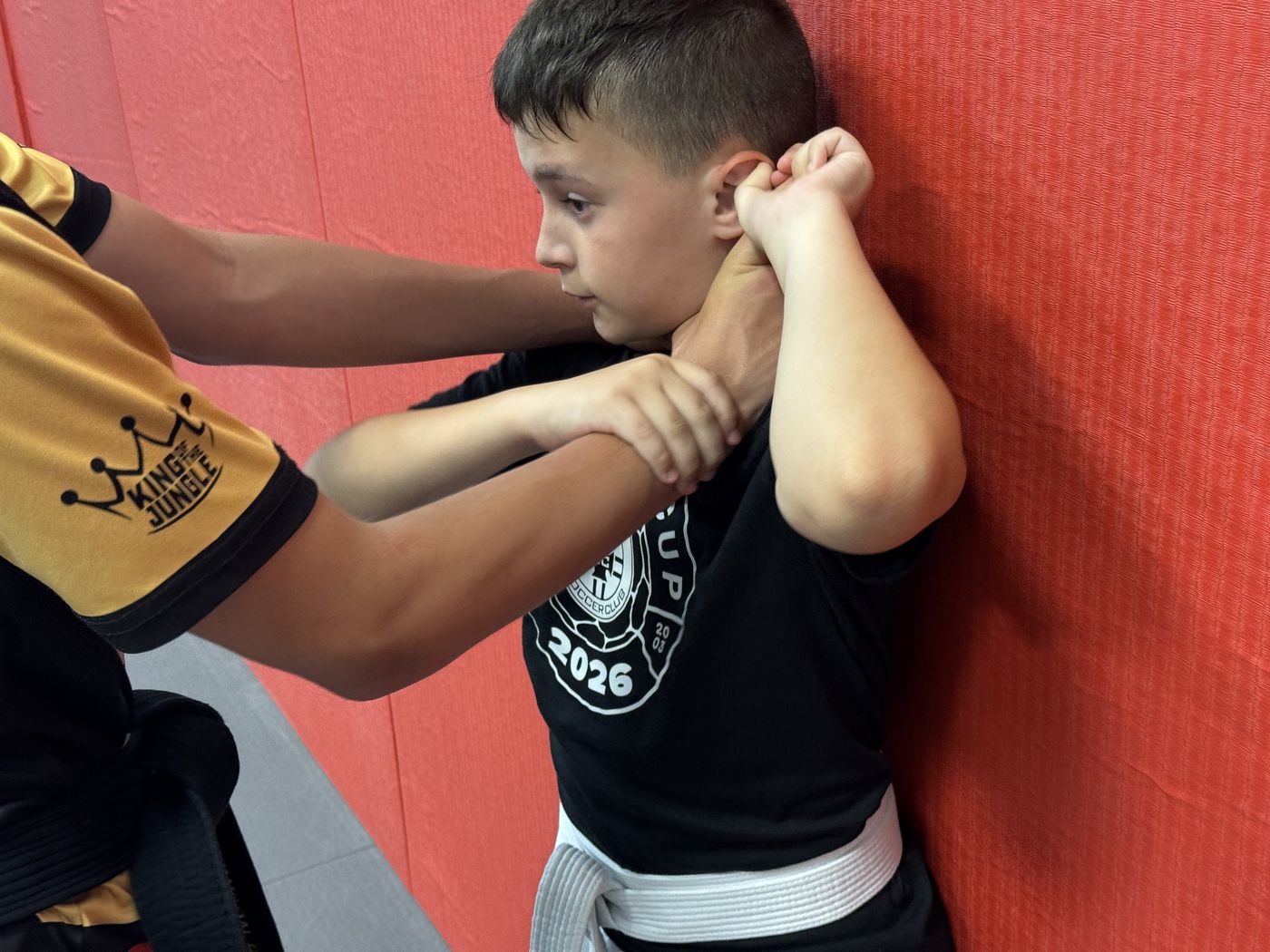 Kids Jiu-Jitsu student practicing a self-defense escape technique