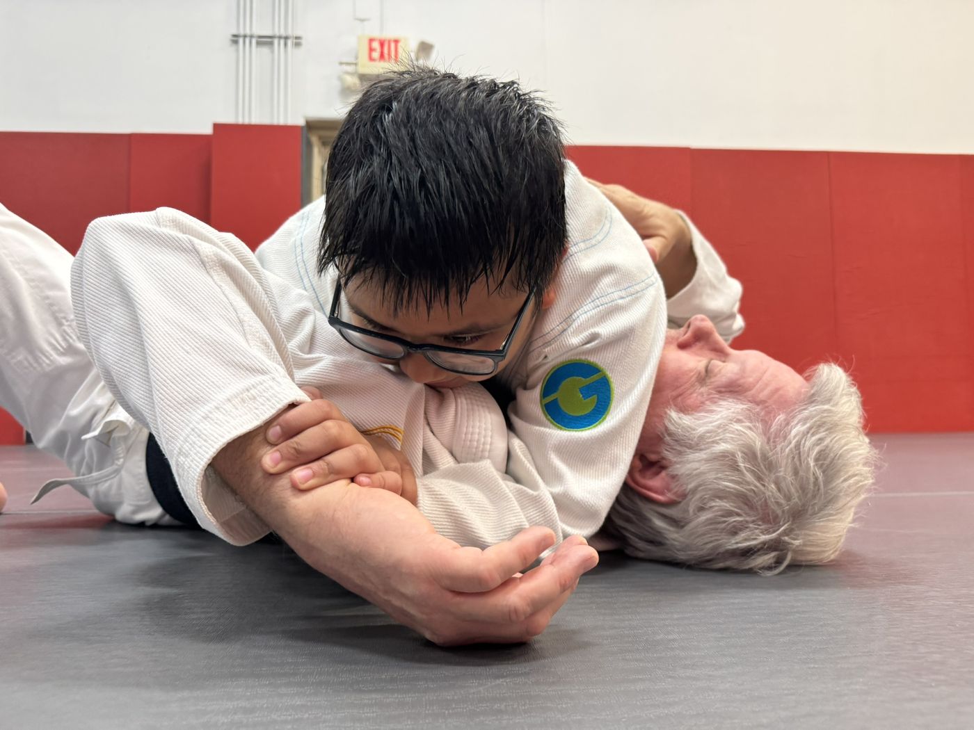 Kids Jiu-Jitsu student practicing an armbar technique at Invictus
